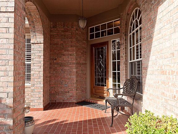 Enjoy an inviting front porch and enter through a solid mahogany leaded glass door.