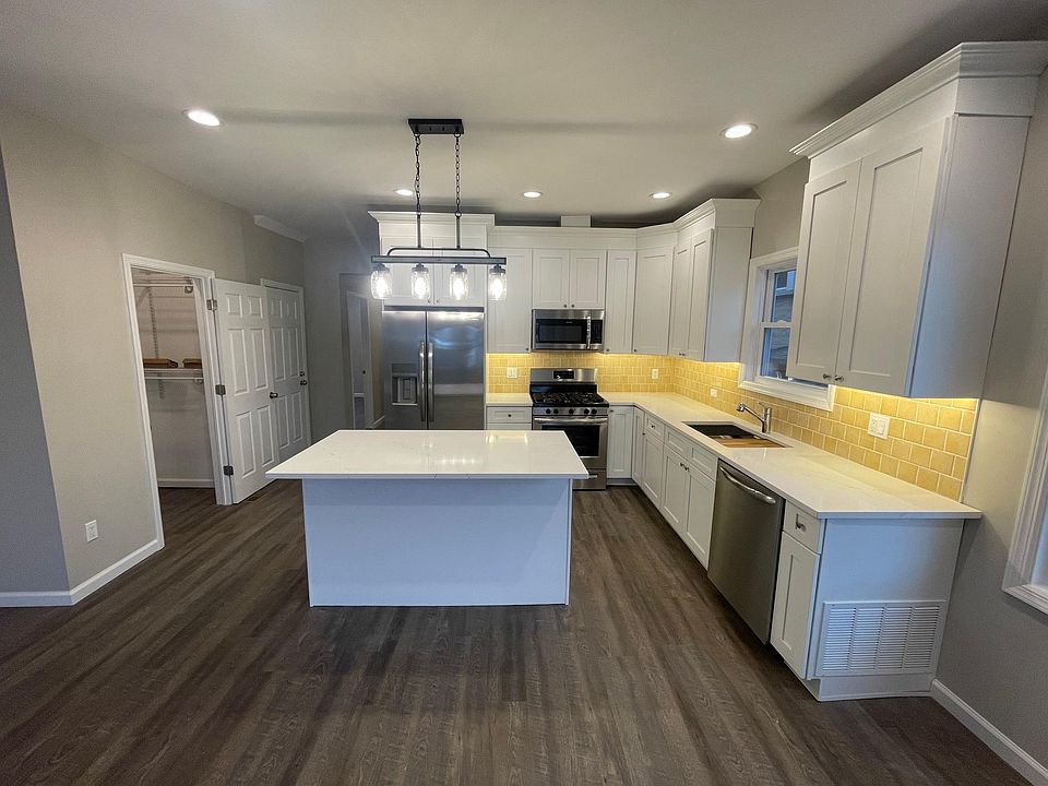 Kitchen with undercounter lighting and with pantry to the left.