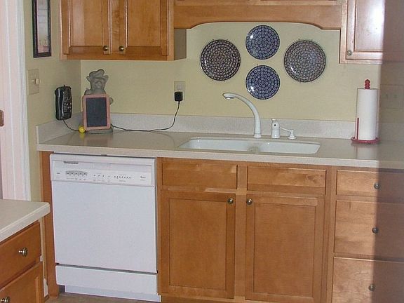Maple Cabinets throughout kitchen with Stainless Steel Fridge.