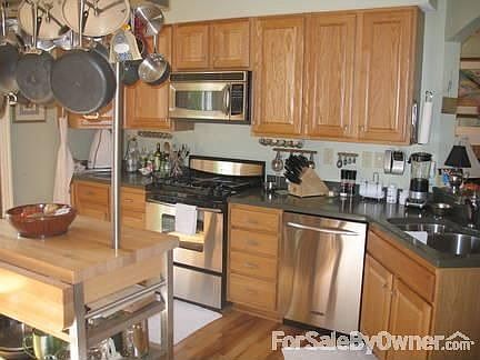 COOK'S KITCHEN : Oak Cabinets; KitchenAid SS Appliances; Laundry in the Kitchen w/Storage