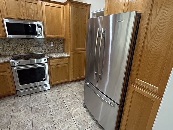 Kitchen with Jenn-Air refrigator with ice and water