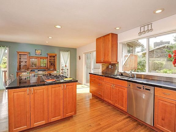 Kitchen with granite island and stainless steel appliances 