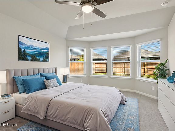 Virtually staged primary suite in the Callaghan floorplan at a Meritage Homes community.