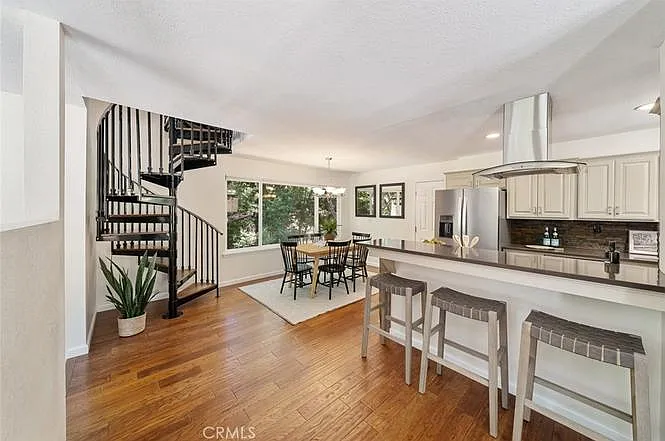 View of spiral staircase up to primary suite