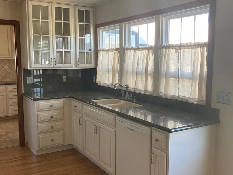 Kitchen sink, dishwasher, garbage disposal, recessed lighting.