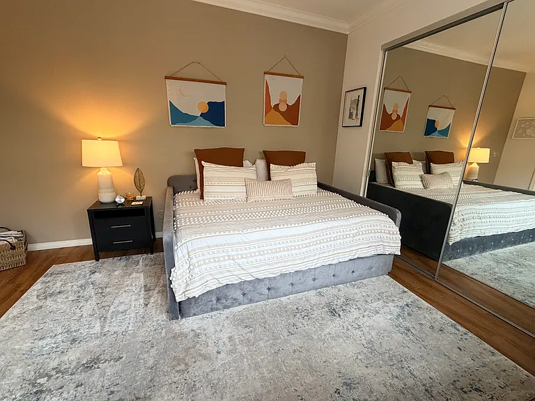 Large guest bedroom with queen bed and attached bathroom