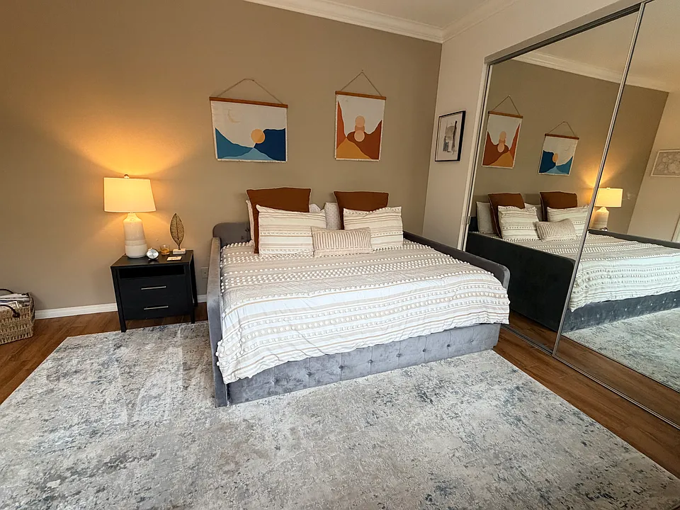 Large guest bedroom with queen bed and attached bathroom