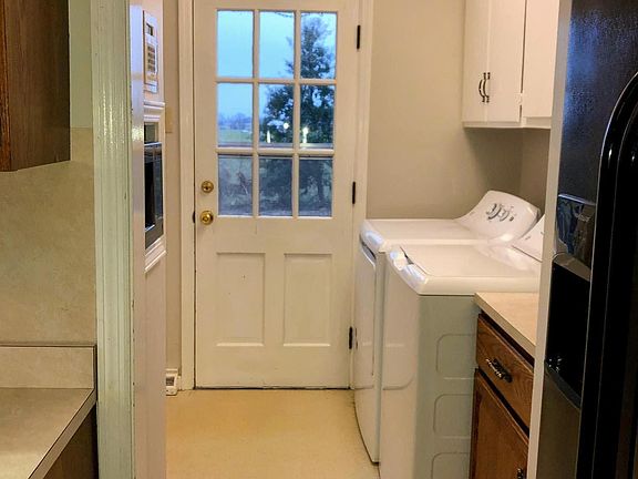 Back entry through laundry room into kitchen. Washer/dryer, microwave, large pantry, broom closet, plenty of cabinet space