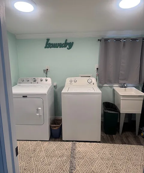 Laundry room with washer, dryer & wash/soaker tub to use upon move in.