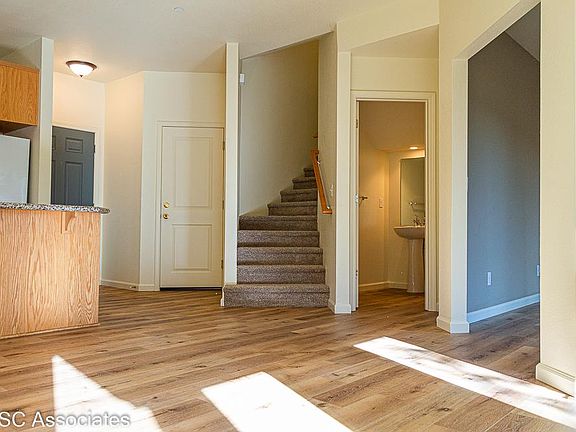 entrance, garage access door, stairwell, half bath, living room