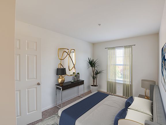 Staged bedroom with bed and dresser