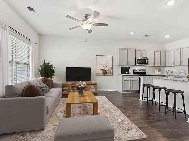 Living room with large window letting in a ton of natural light.