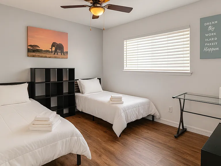Guest bedroom with 2 twin beds and work desk_great for kids or travelers.