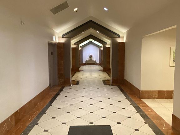 Elevator hallway, mail room to right