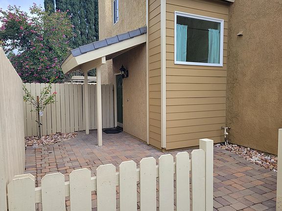 Newly appointed front courtyard offering privacy and street appeal with front porch overhang.