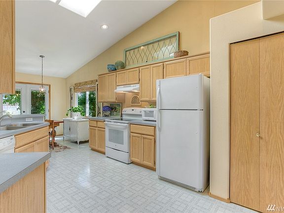 Large open user-friendly kitchen with high vaulted ceilings and skylights. 