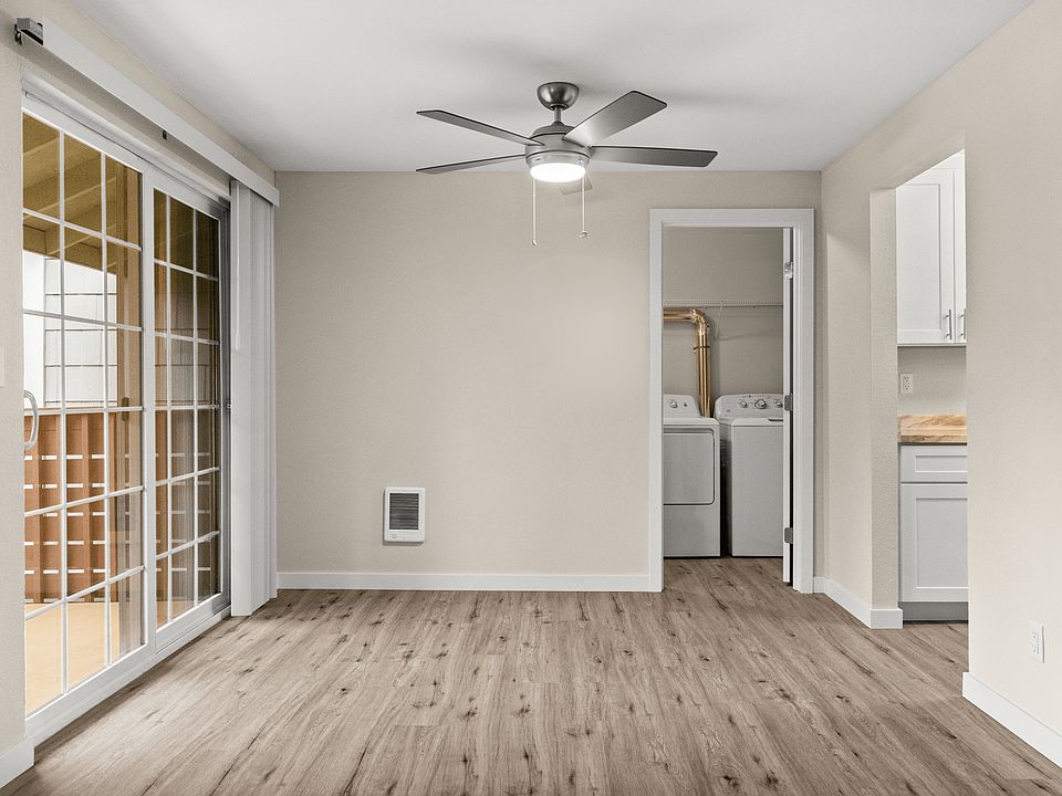 Dining space with modern ceiling fan and in-home laundry access.