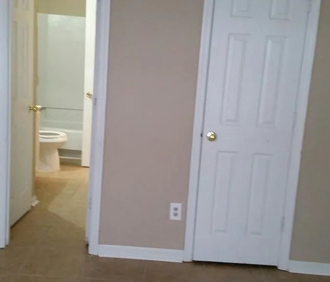 Downstairs bedroom. View to bathroom