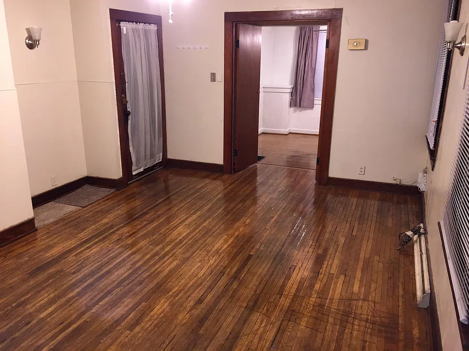 Living room looking at apartment door and bedroom doors open