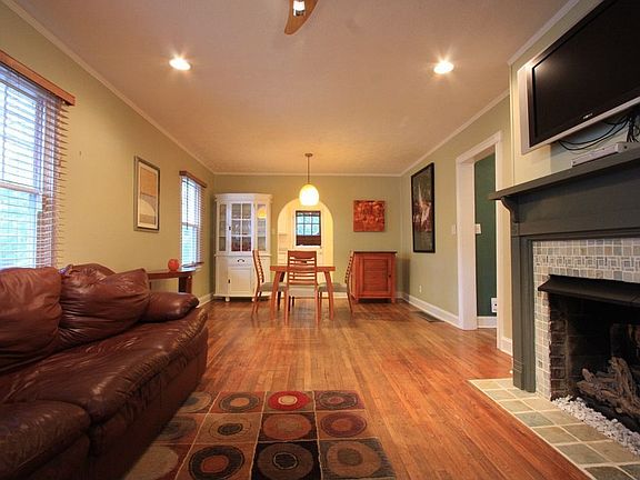 Living room opens up to the dining room and kitchen beyond.