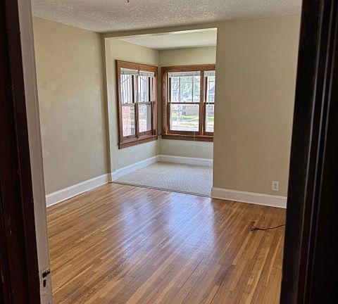Main floor first bedroom with front sitting area or desk space.