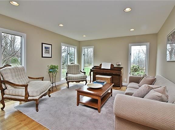 Tranquil living room with distant river views and an abundance of natural light.