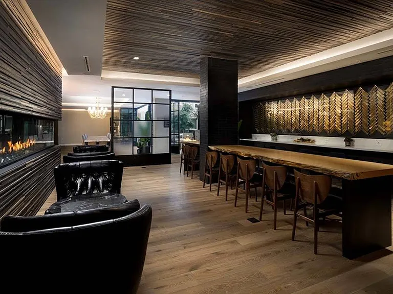 Resident clubroom features indoor fireplace with stylish accents for cozy gatherings