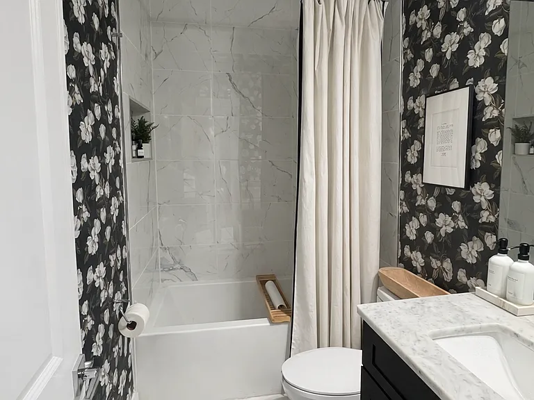 The guest bath features a large soaking tub