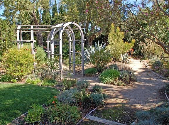 Lighted pathways wind through quiet, private backyard