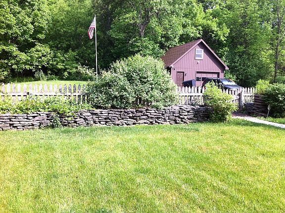 From front door across yard to street and detached garage.