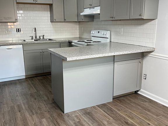 Kitchen with bar next to dining room.