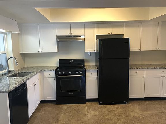 Brand new kitchen with beautiful white shaker cabinets, white ornamental granite stone, large floor tiles, newer dishwasher and fridge, upgraded stove.