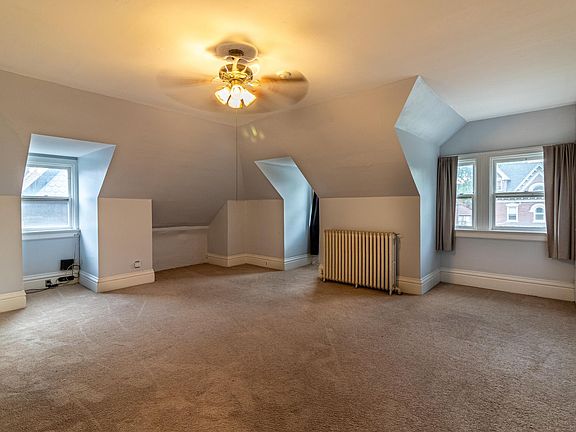 Large living room with lots of light with windows