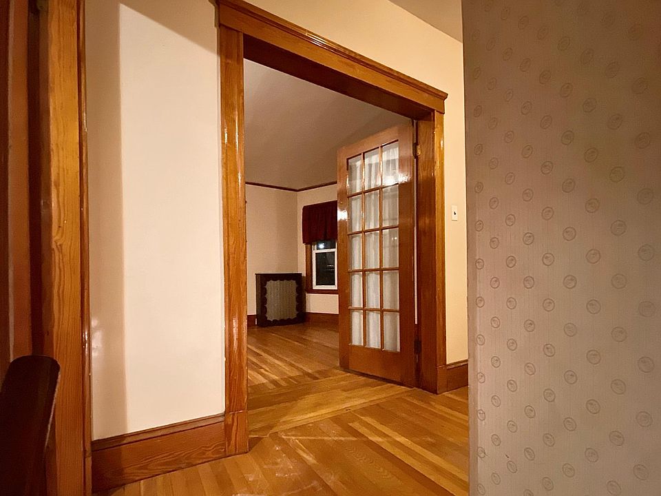 Entrance to the second floor; French doors lead into living room