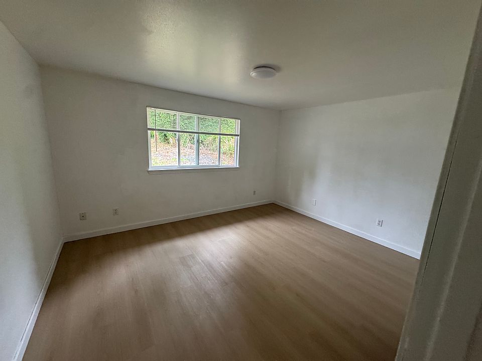 Bright secondary bedroom with new hard-surface flooring, a spacious closet, and abundant natural light.