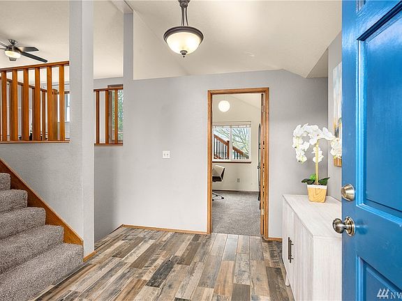 Open foyer with skylight and new tile flooring.