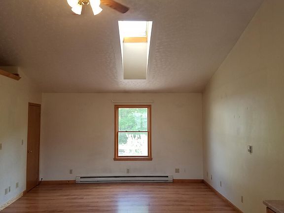 Enter between kitchen and laundry area, into large main room