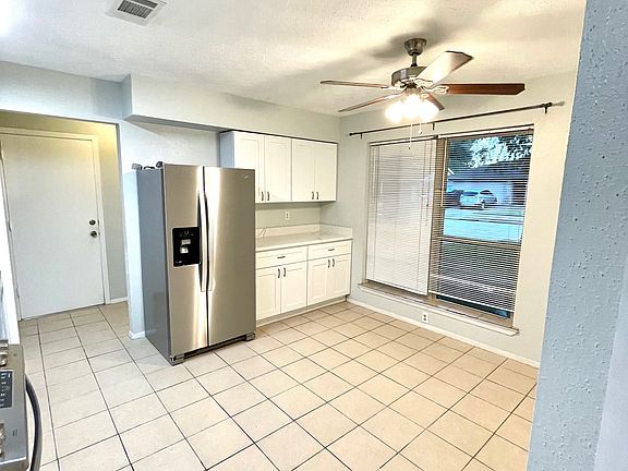 Modern kitchen features quartz countertops and stainless-steel appliances.
