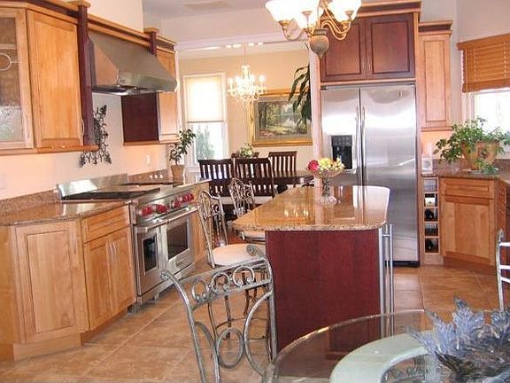 Gourmet kitchen, wolf stove, wine chiller, custom cabinets, granite counters, 