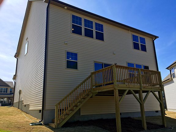 Deck overlooks woods.