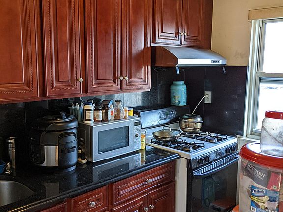 granite counter and cherry wood cabinets
