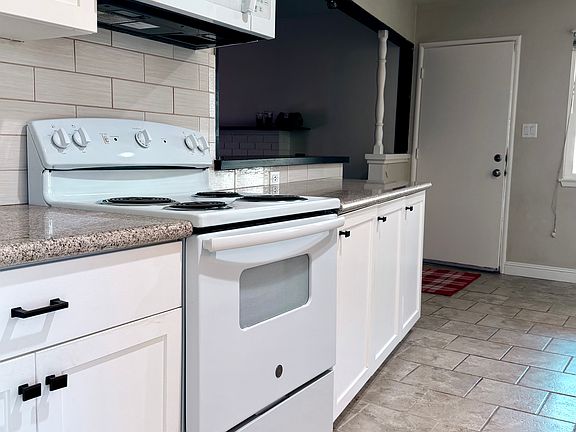 Newer microwave and oven with updated cabinetry