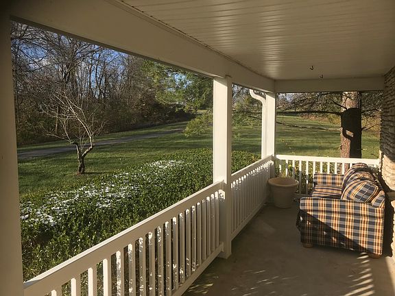 Front porch and driveway leading to house.