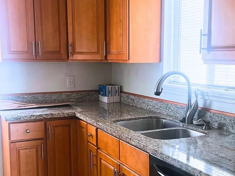 Upstairs kitchen with wood cabinets