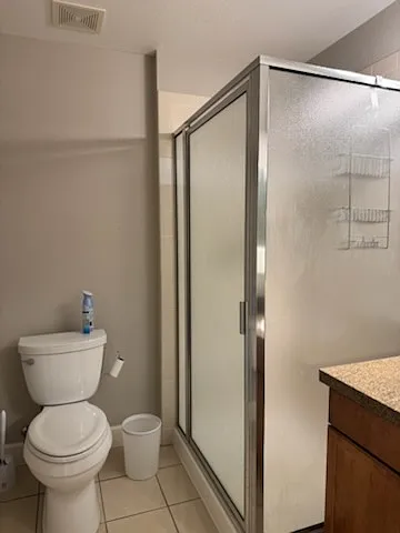 Second bathroom includes single sink with granite countertop and shower.