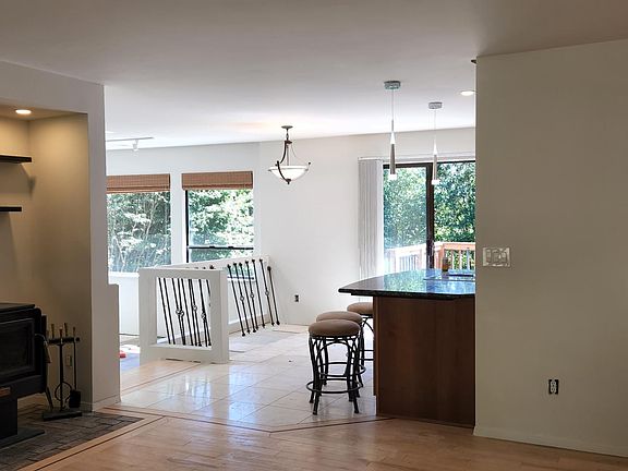 View from entrance. Open living to dining family room and kitchen look out to back yard. Wood burning fireplace place.
