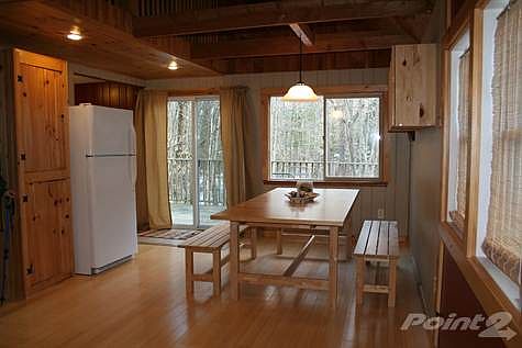 Dining area off kitchen. Note balcony above and sliding patio doors to deck