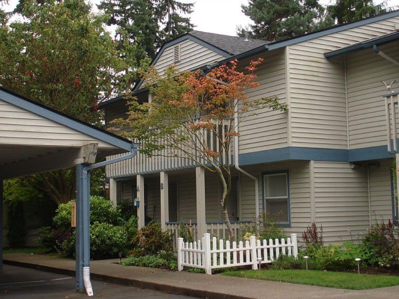 Direct entrance to 2-story townhome w/balcony & picket fence w/garden; covered parking in front