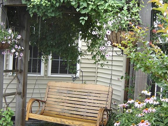 Swing with climbing clmatis overhead