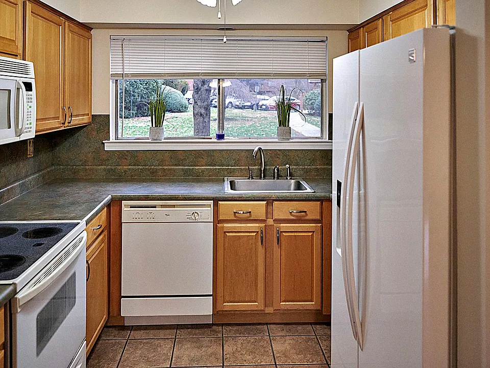 Is larger in real life :) good workspace and many cabinets. U Shaped.